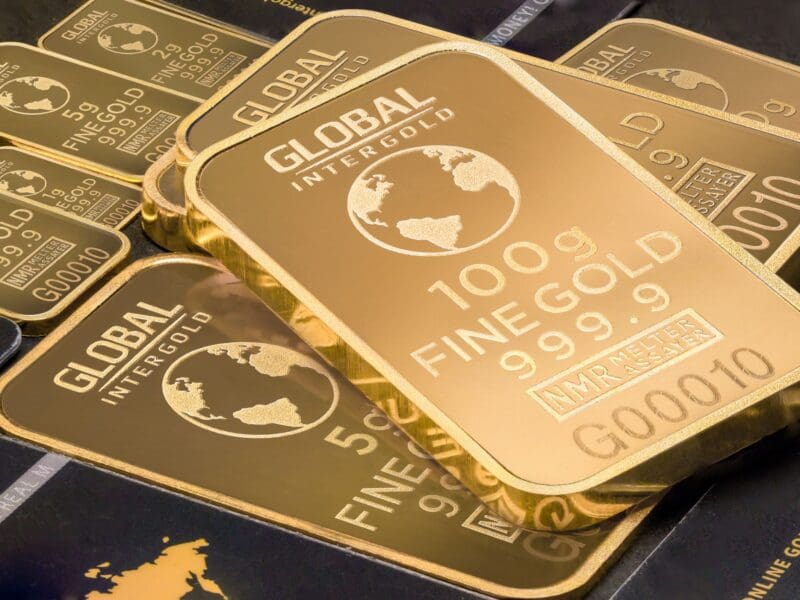Stack of 100g fine gold bars with global design. Stack of 100g fine gold bars with global design.