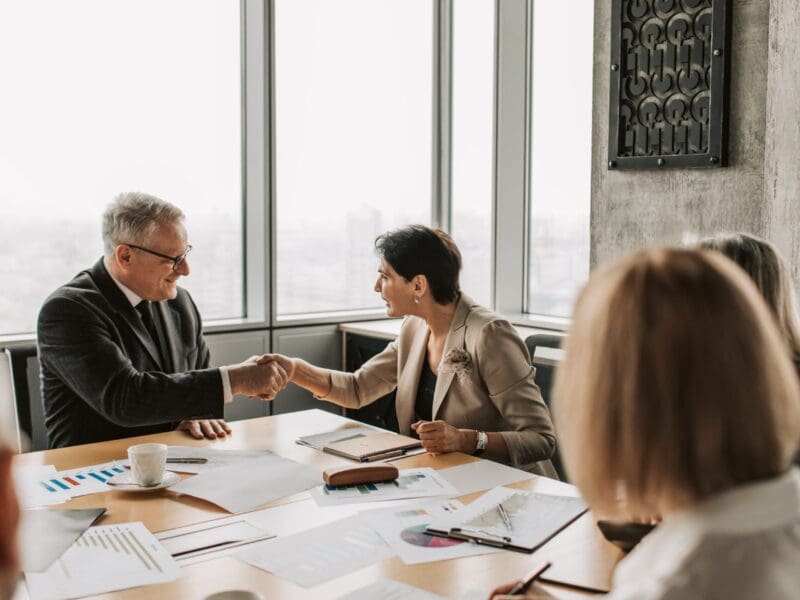 Two professionals shaking hands in a business meeting. Two professionals shaking hands in a business meeting.